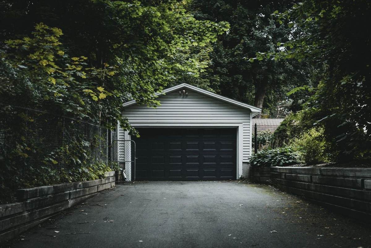 A home with a detached garage at the end of a driveway
